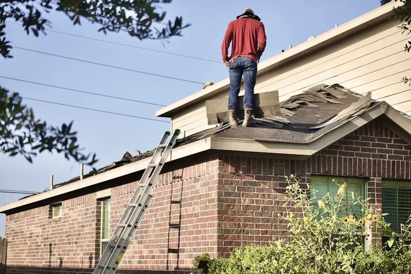 Professional roofer working on a residential roof in The Colony